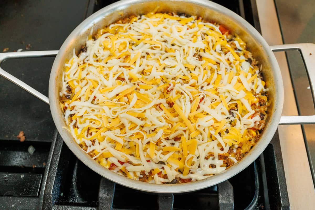 Mexican Beef and Rice Skillet is a quick, 30-minute meal—seasoned beef, loaded rice, and gooey melted cheese. The perfect one-pan wonder! Mexican Ground Beef and Rice Skillet topped with shredded Mexican cheese blend