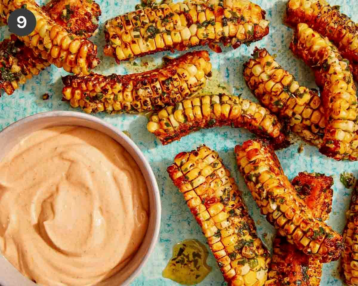 Corn ribs on a platter with a dipping sauce.