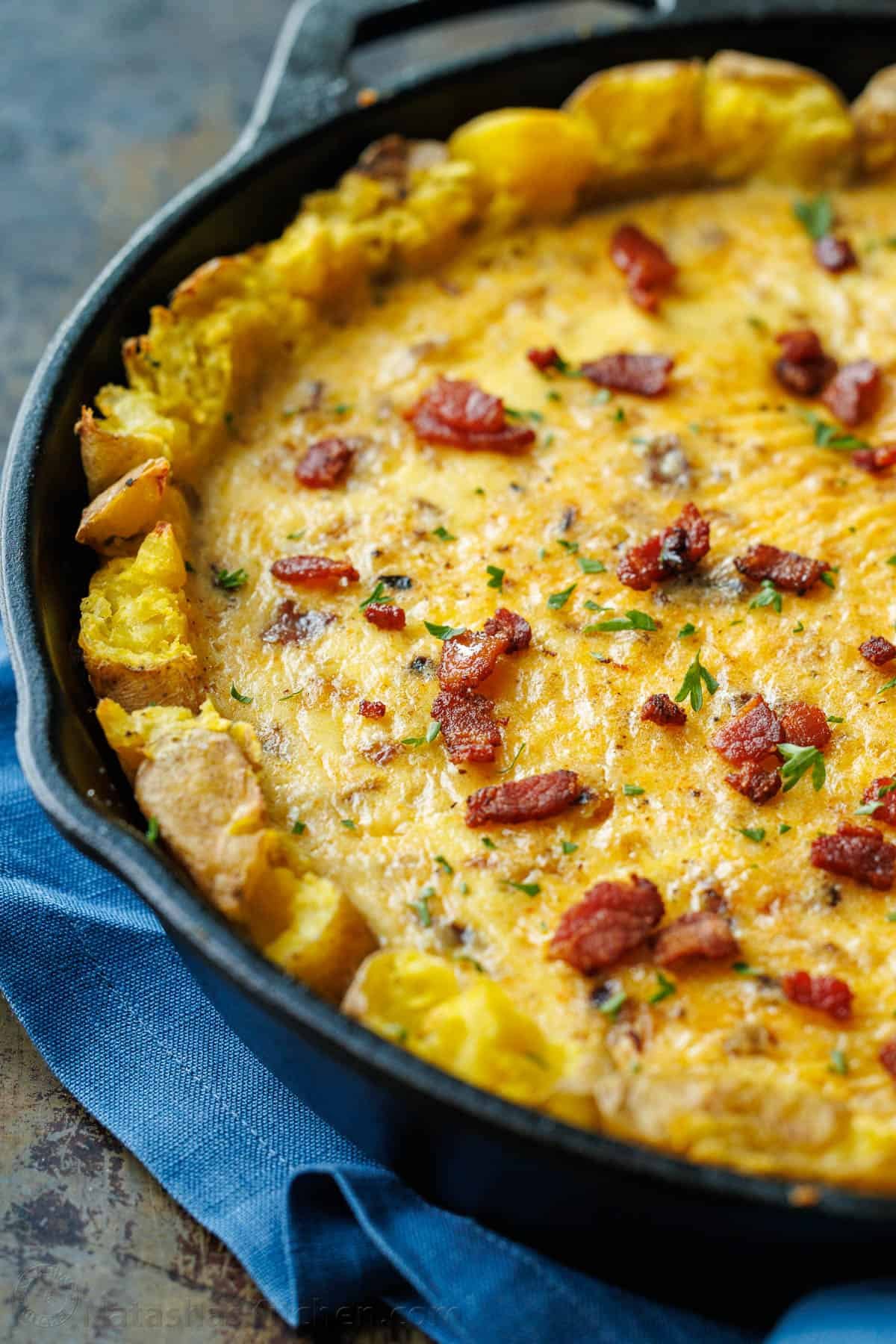Our Potato Crusted Quiche replaces traditional dough with smashed potatoes for a tasty, gluten-free option that's easy to make and perfect for brunch. Potato Crust Quiche in a 10-inch cast iron skillet, topped with bacon and parsley