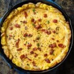 Potato Crust Quiche in a cast iron skillet, topped with bacon and parsley