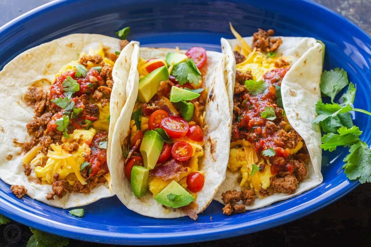 See our best breakfast ideas for busy weekday mornings and special holidays alike. Try out both sweet treats and healthy breakfast recipes. Breakfast tacos on blue platter