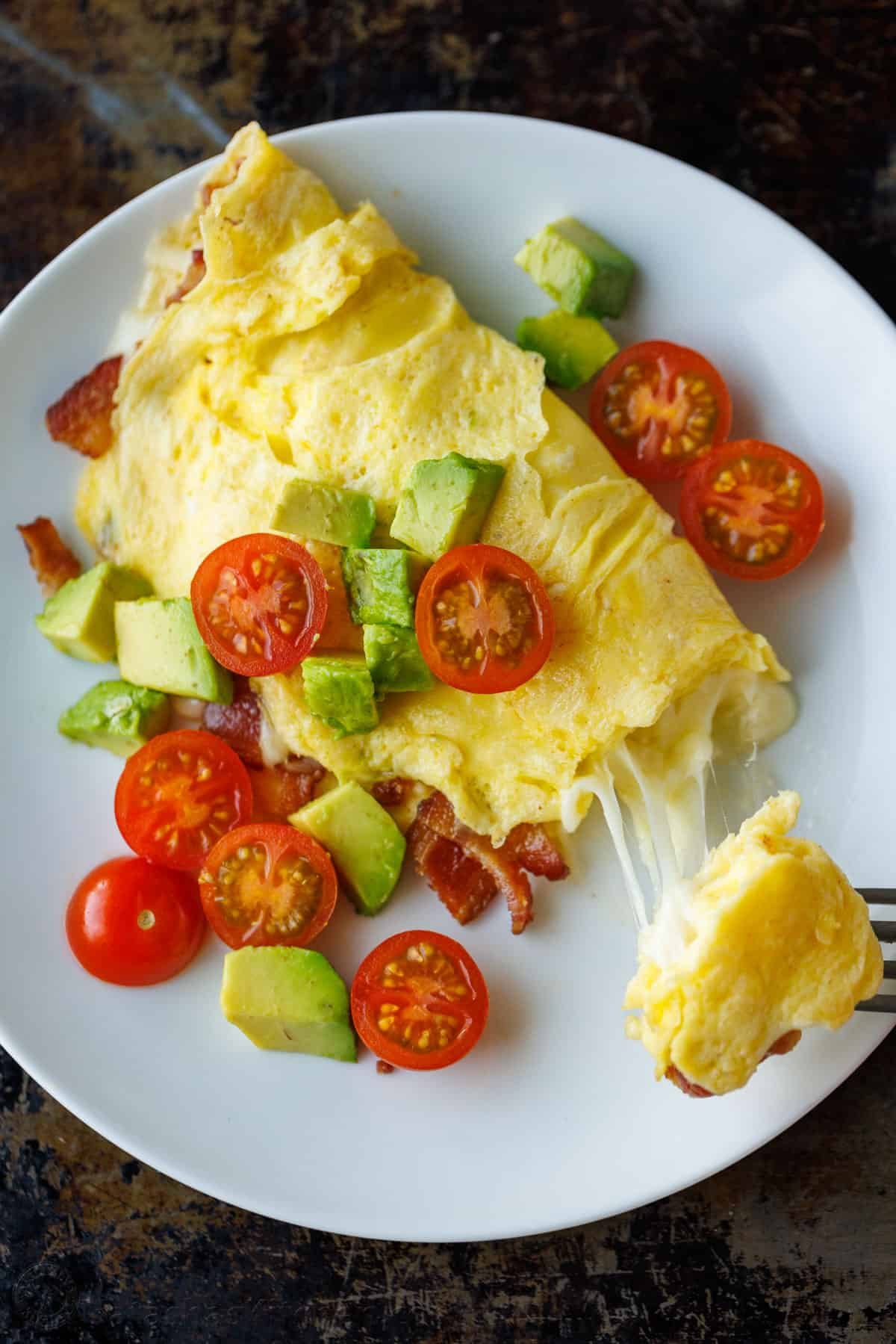 See our best breakfast ideas for busy weekday mornings and special holidays alike. Try out both sweet treats and healthy breakfast recipes. cheesy omelette on a plate
