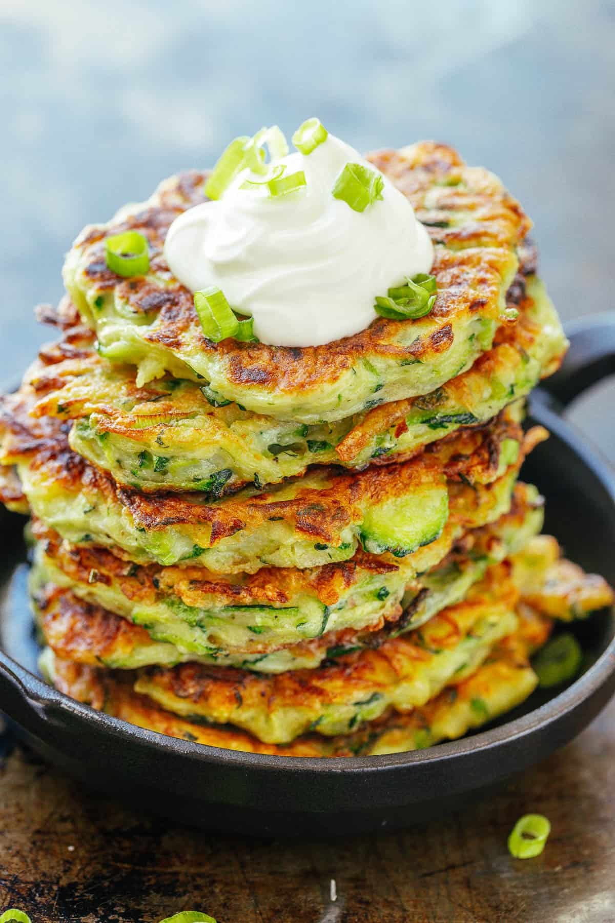 See our best breakfast ideas for busy weekday mornings and special holidays alike. Try out both sweet treats and healthy breakfast recipes. Stack of zucchini fritters topped with sour cream and scallions