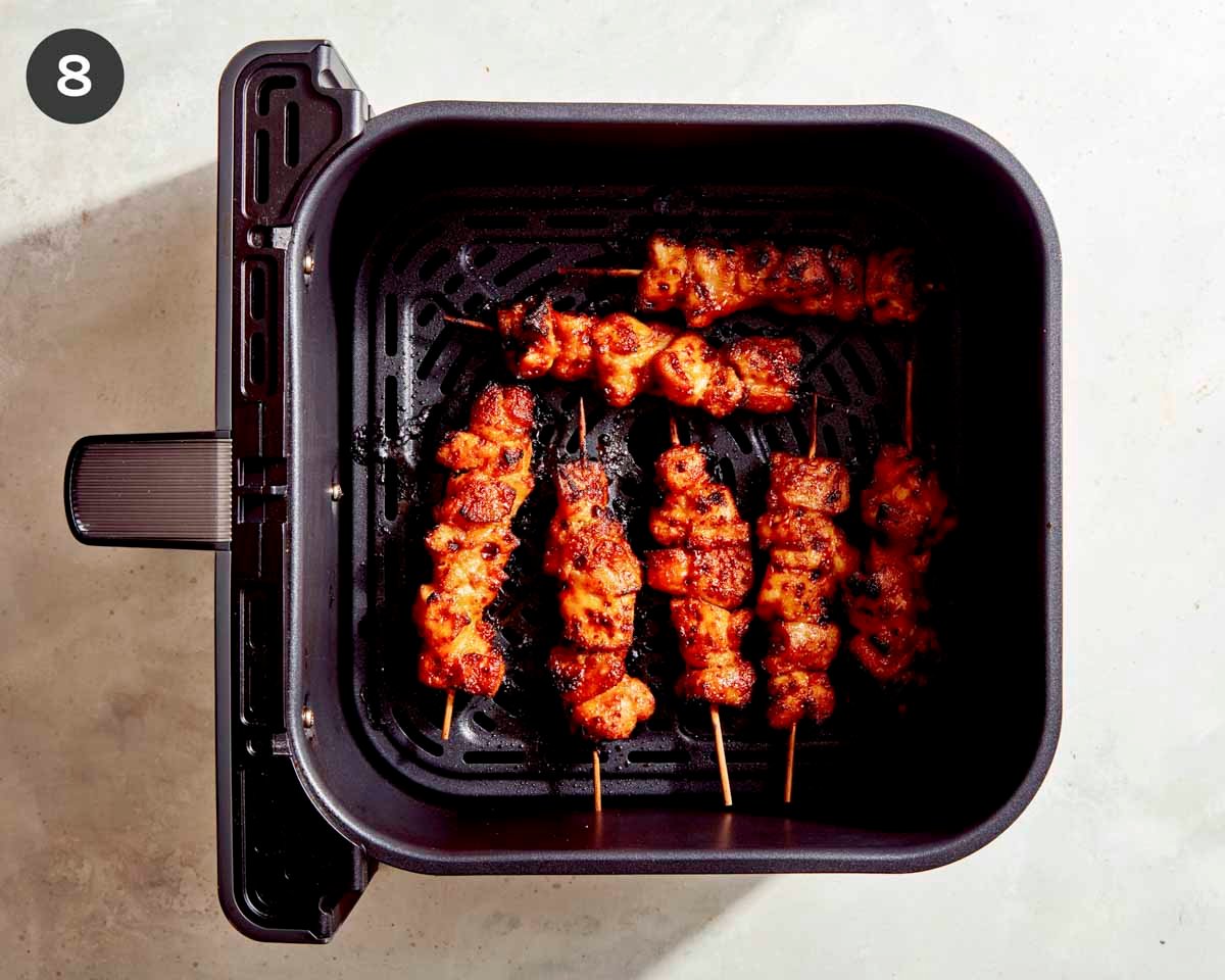 Cooked air fryer bang bang chicken skewers.