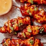 Air fryer bang bang chicken skewers on a platter.