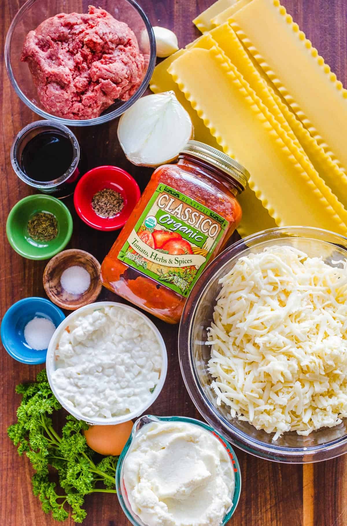 This easy Lasagna Recipe is meaty, cheesy, and flavorful. Perfect for a weeknight dinner or feeding a crowd, readers agree it's the best! Overhead view of ingredients for lasagna