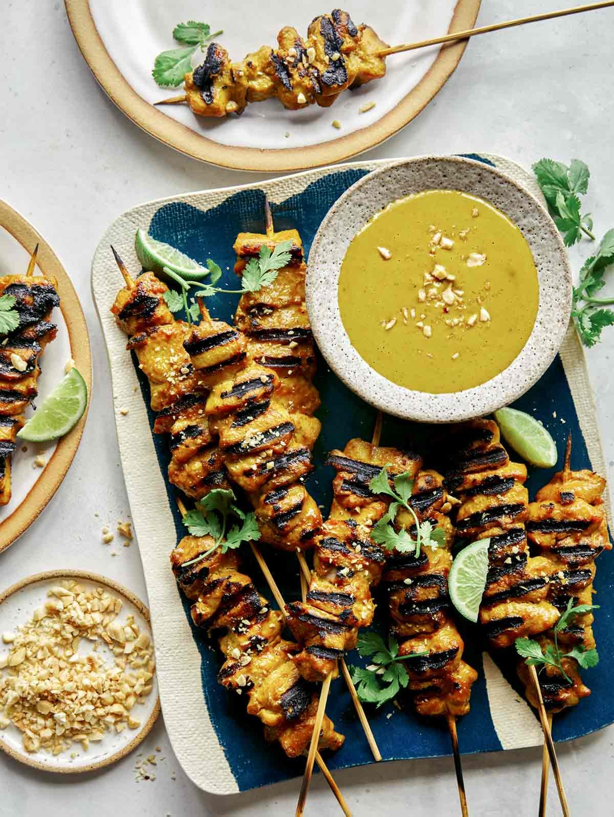 Chicken satay recipe with some plated on the side.