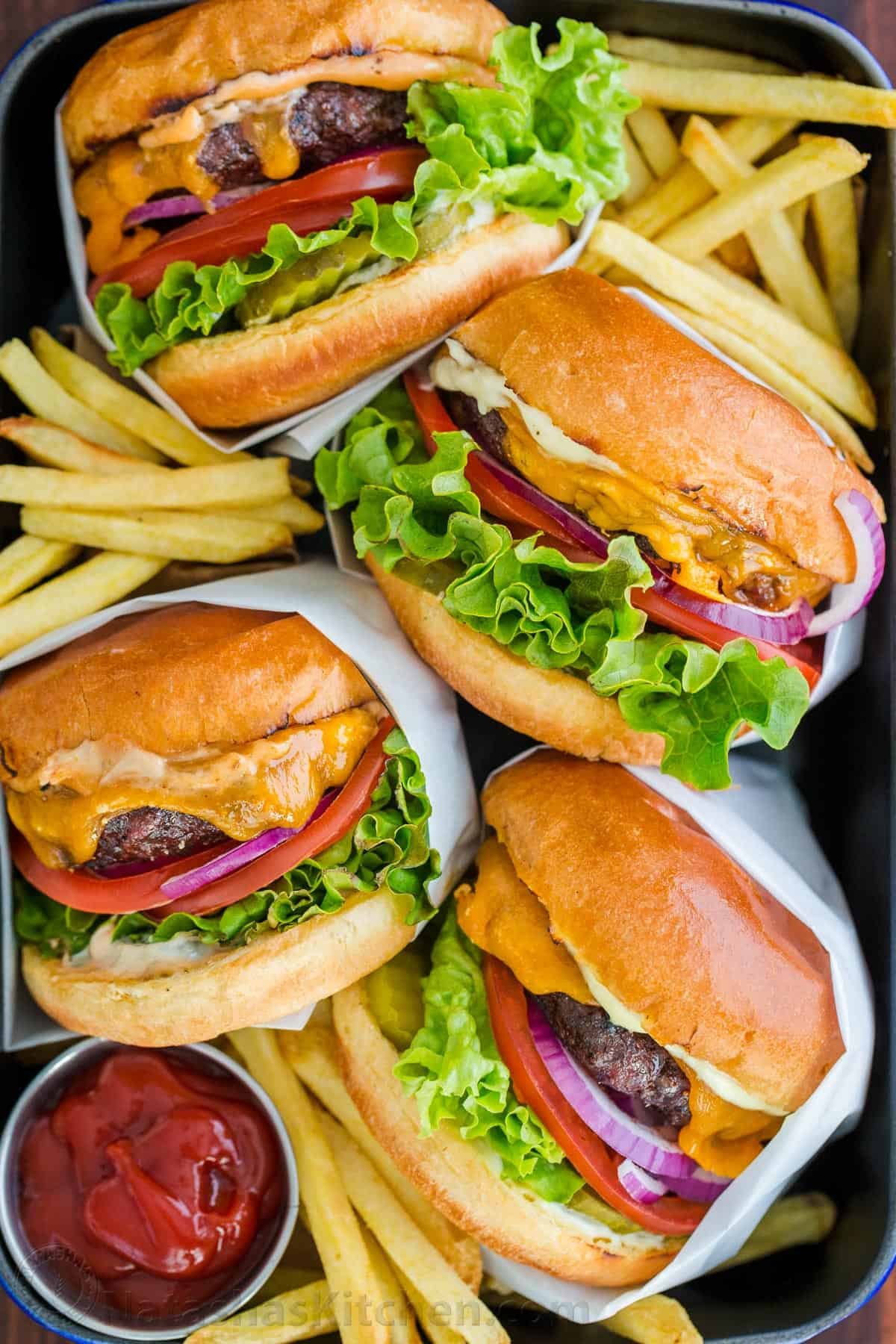 burgers and fries on serving dish