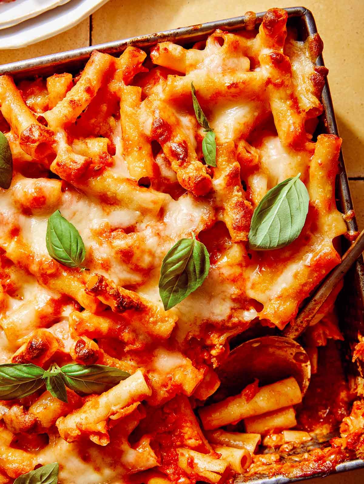 Close up on a baking dish full of baked ziti.
