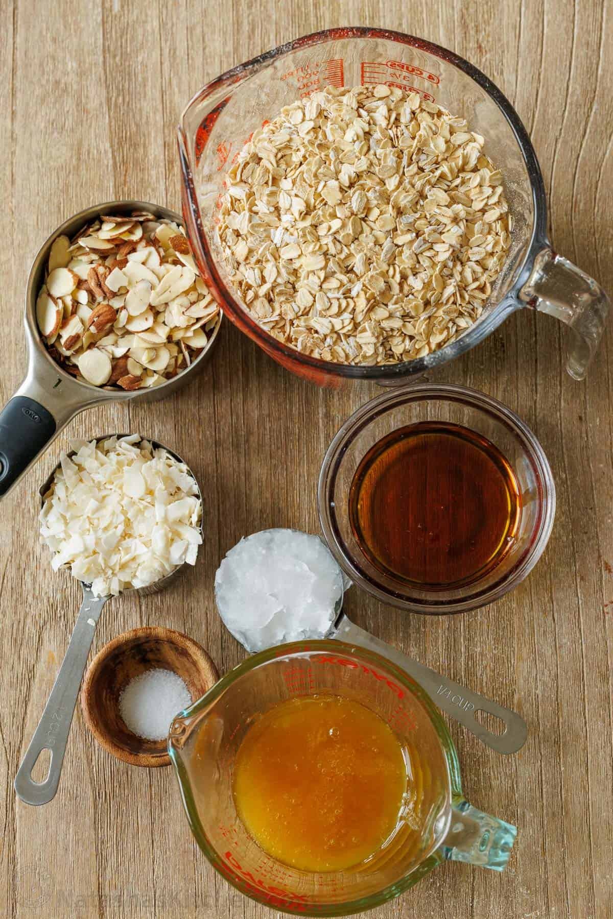 This Homemade Granola Recipe is one of my family's go-to healthy breakfast recipes because it's quick to make and ready to eat all week long. Ingredients for homemade granola recipe including oats, almonds, coconut flakes, maple syrup, honey, coconut oil and salt.