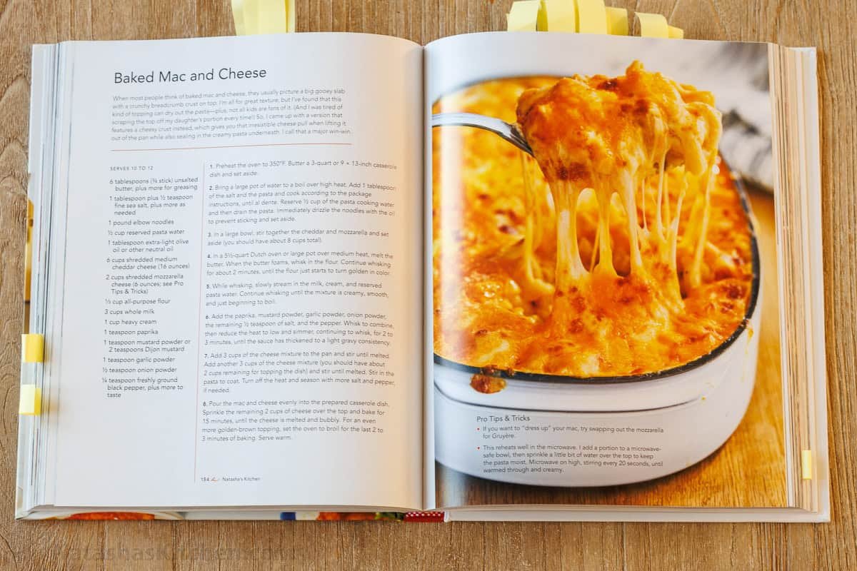 My Easy homemade Baked Mac and Cheese swaps the breadcrumbs for a crowd-pleasing cheese topping. It's perfectly gooey and easy to make. Natasha's Kitchen Cookbook open on the counter showing the easy Baked Mac and Cheese Recipe