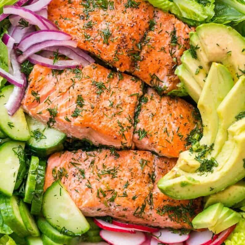 This avocado salmon salad recipe is loaded with all of the best salad ingredients; crisp cucumber and lettuce, and juicy pan seared salmon. The lemon dill dressing is so easy and gives this salmon salad amazing fresh flavor. | natashaskitchen.com