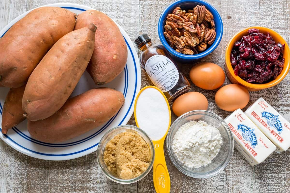 Sweet Potato Casserole with irresistible crunchy pecan topping. This sweet potato bake is smooth and puffs up while baking. A favorite Thanksgiving side! #sweetpotatocasserole #sweetpotatocasserolerecipe #sweetpotato #sweetpotatorecipes #natashaskitchen #thanksgiving #christmas Ingredients for the famous Thanksgiving side dish with sweet potatoes, eggs, craisins, pecans, sugar topping and butter