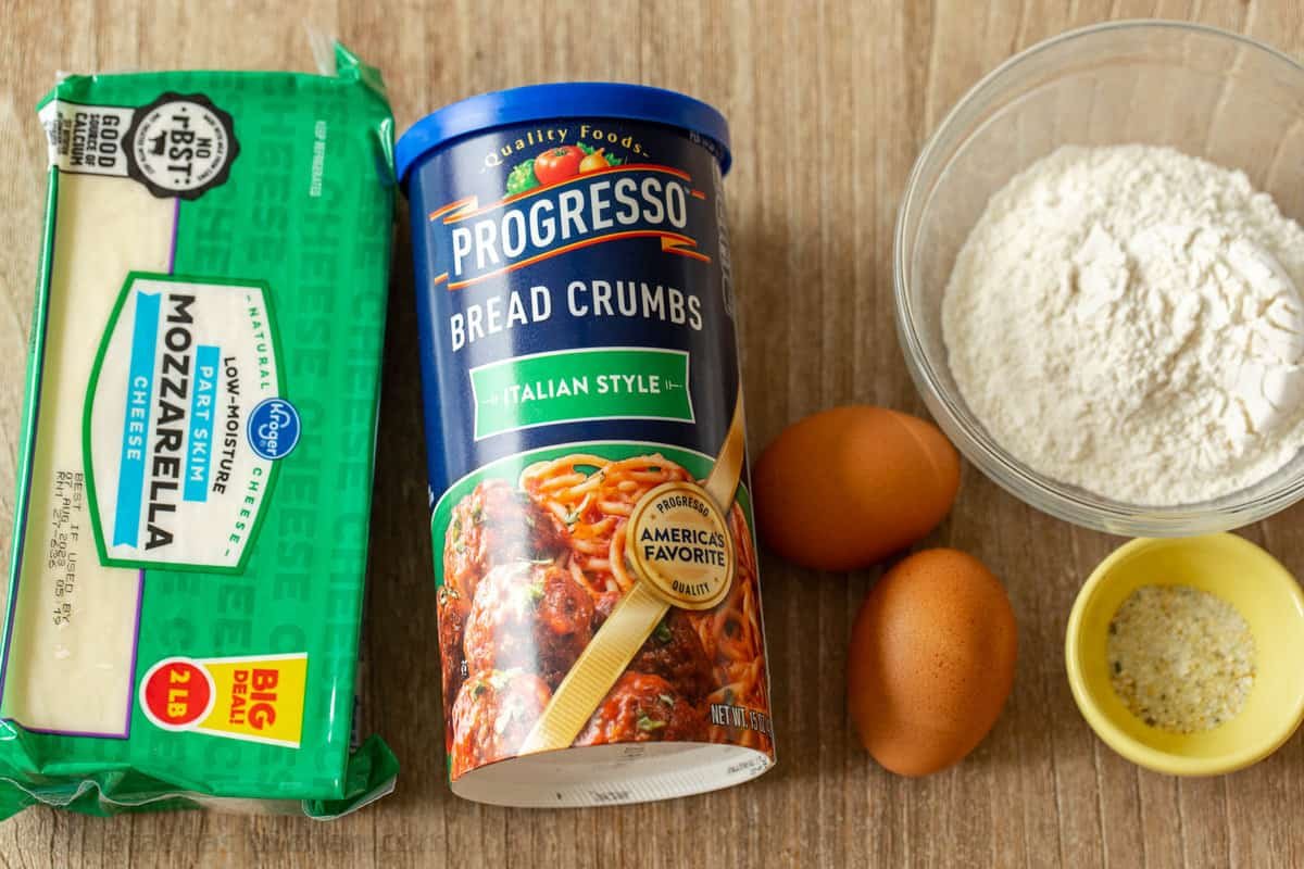Homemade mozzarella sticks are irresistibly crispy on the outside and gooey and melty in the middle. The ultimate snack or party appetizer! The ingredients for homemade mozzarella cheese sticks.