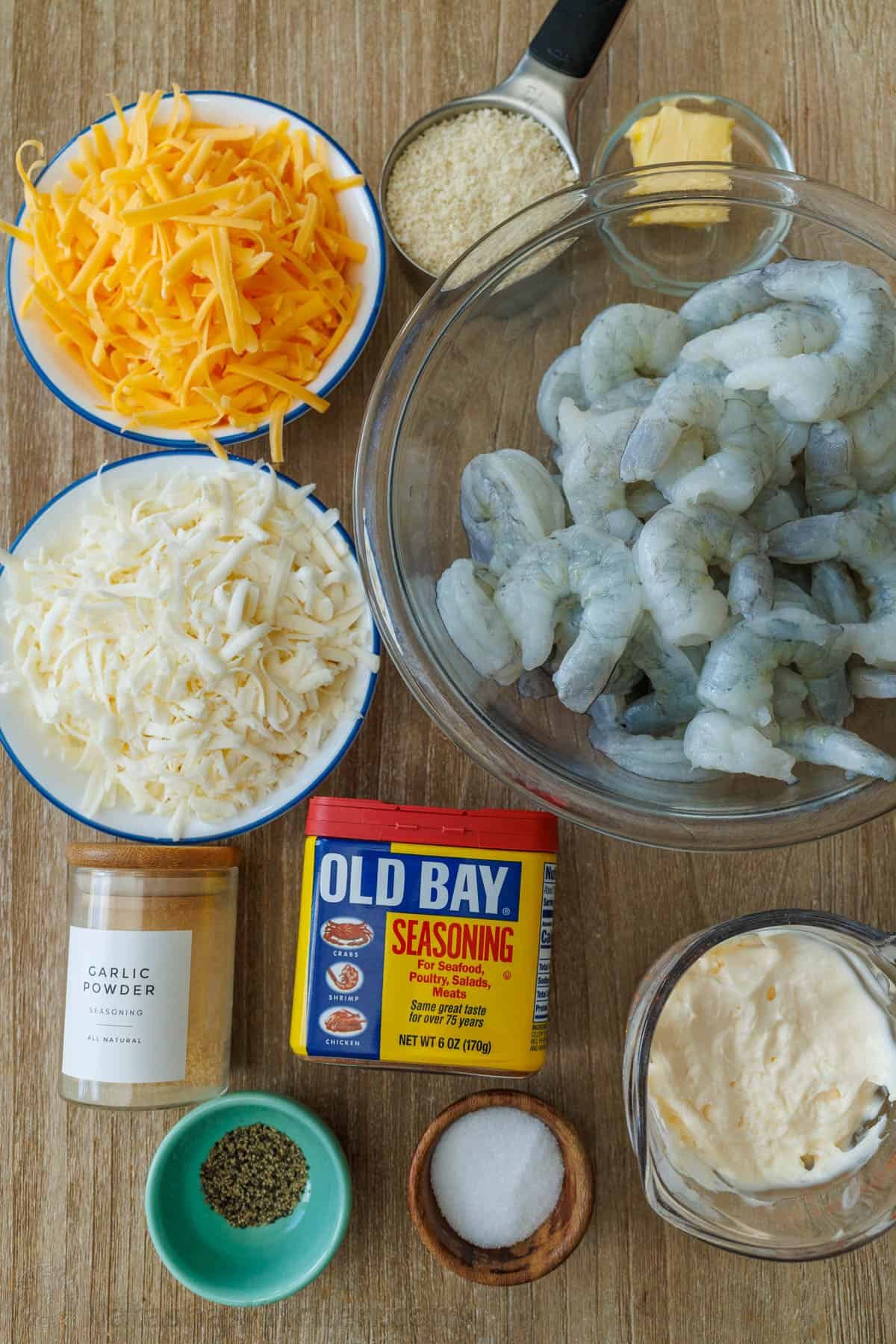 My Shrimp casserole recipe is an easy 30-minute dish for holidays or weeknights alike! Cheesy shrimp filling topped with crunchy breadcrumbs. Ingredients for seafood bake with mozzarella cheese, cheddar cheese, garlic powder, Old Bay Seasoning, pepper, salt, mayo, butter and breadcrumbs