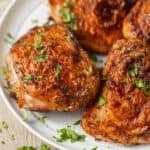 Air Fryer Chicken Thighs served on a plate with parsley garnish