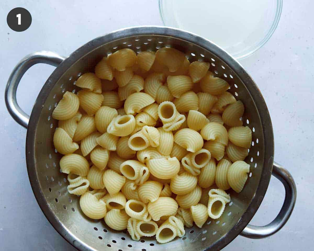 Pasta for stovetop mac and cheese in a colander drained.