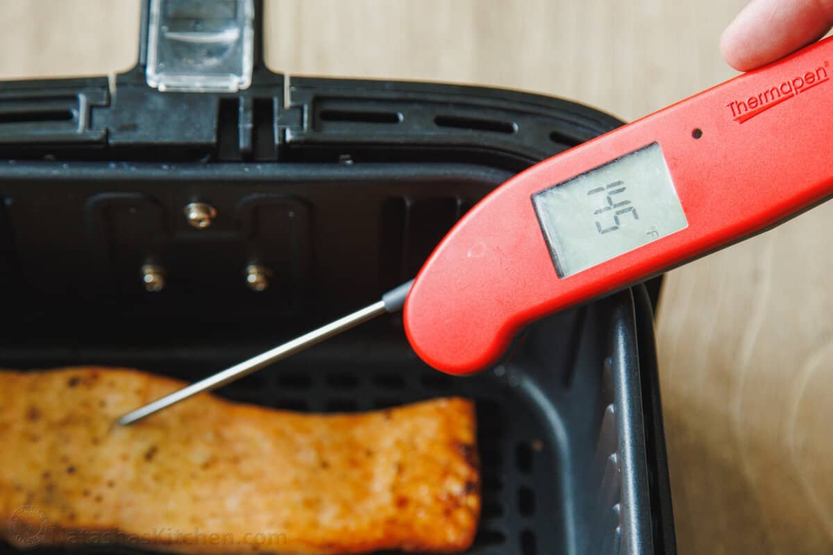 Air Fryer Salmon is one of the best ways to cook salmon! Have juicy, perfect salmon on the table in 10 minutes with this easy dinner recipe. An instant-read thermometer stuck into the middle of a salmon fillet, with the temperature reading 145ºF.