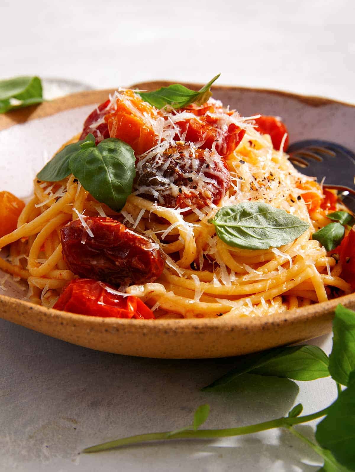 A big pile of butter roasted cherry tomato pasta in a bowl.