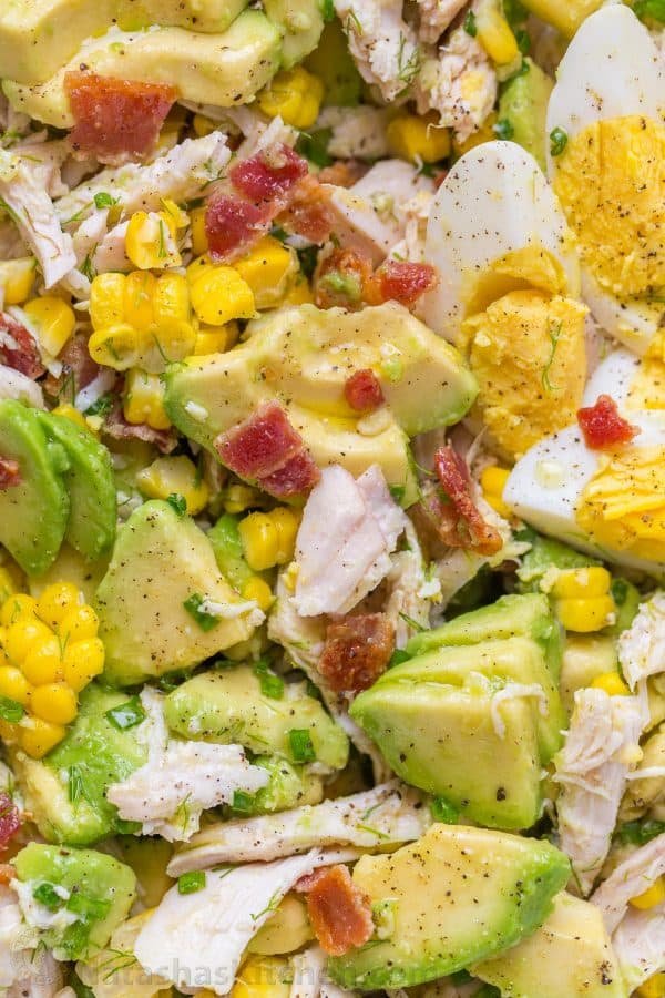 This Avocado Chicken Salad recipe is a keeper! Easy, excellent chicken salad with lemon dressing, plenty of avocado, irresistible bites of bacon and corn | natashaskitchen.com
