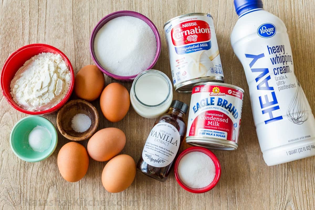 Ingredients for the best tres leches cake recipe Tres Leches Ingredients with heavy whipping cream, sweetened condensed milk, evaporated milk, eggs, sugar, flour, salt and baking powder