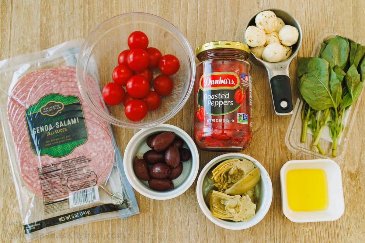Ingredients to make crispy salami cups antipasti Ingredients to make Salami Cups Antipasto: Salami, tomato, marinated bell peppers, artichoke hears, olives, olive oil, fresh basil leaves, mozzarella cheese