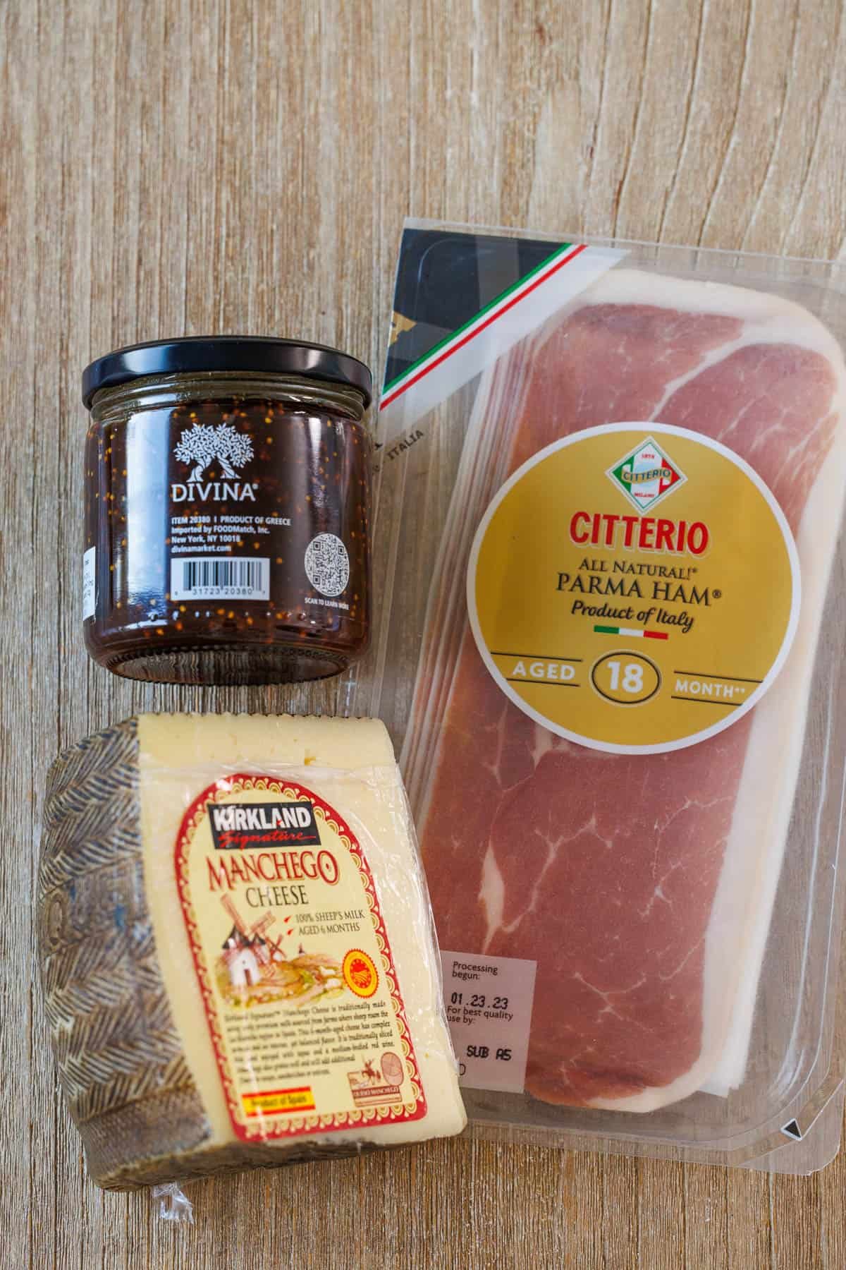 Easy manchego cheese bites with fig preserves and prosciutto take less than 5 minutes to make, but they look elegant and taste divine! 3 ingredients for an easy appetizer including fig jam, Proscuitto and a wedge of Manchego