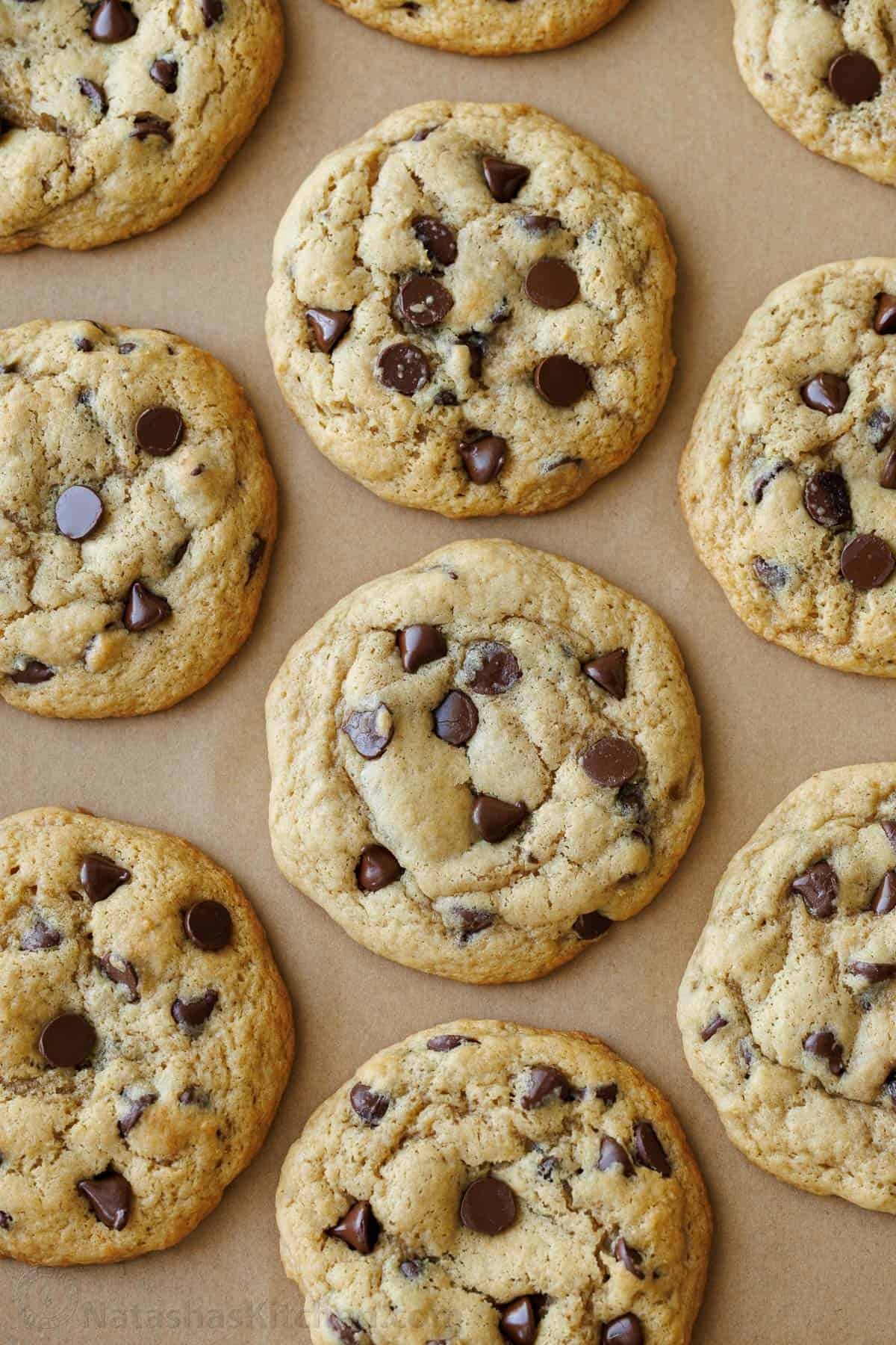 Soft-chewy sourdough chocolate chip cookies made with discard and loaded with chocolate chips. Step-by-step photos and easy video tutorial. Baked sourdough discard chocolate chip cookies recipe on a cookie sheet