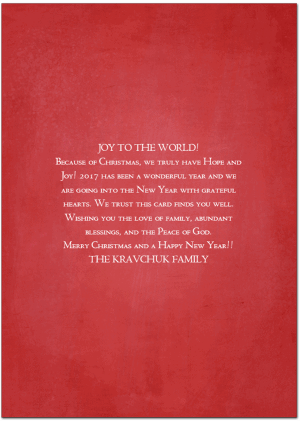 Christmas card greetings written in white on a red card
