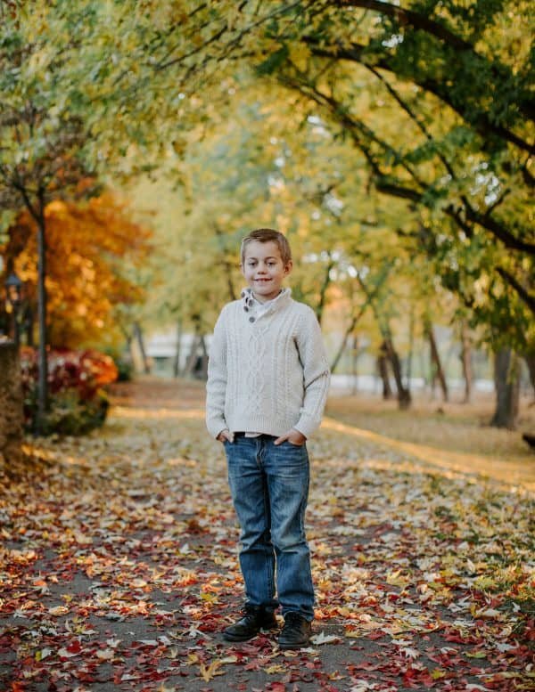 A young boy standing in a park