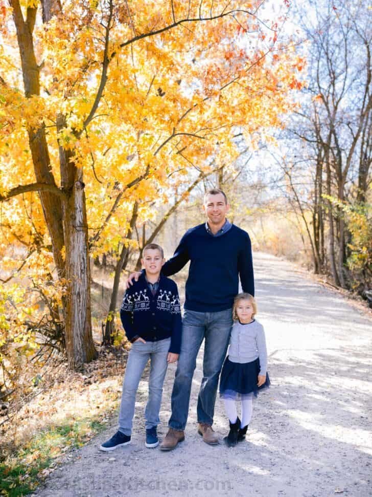 A photo of a father and two children. 
