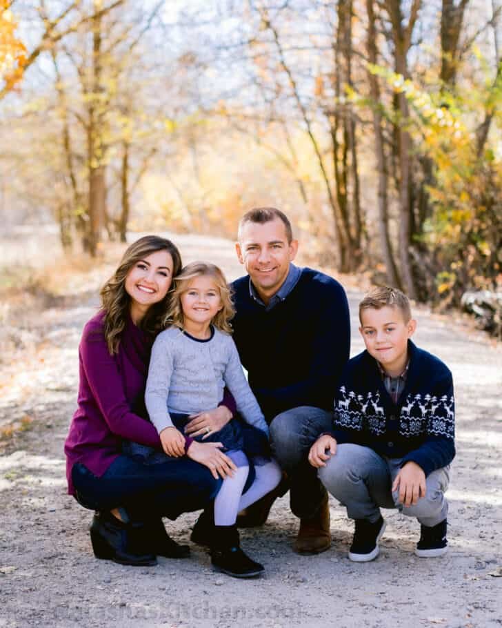 Natasha Kravchuk and with husband and two children posing for the camera.