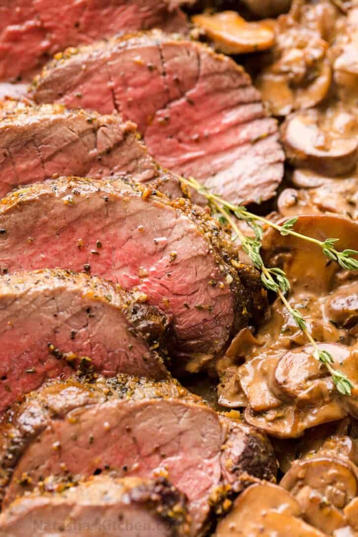 Beef Tenderloin with Mushroom Sauce is a holiday-worthy and impressive main course. Learn how to prep, tie, and cook a beef tenderloin roast in the oven. Beef tenderloin cooked to medium doneness temperature