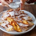 Dusting confectioners sugar over Angel Wing Cookies