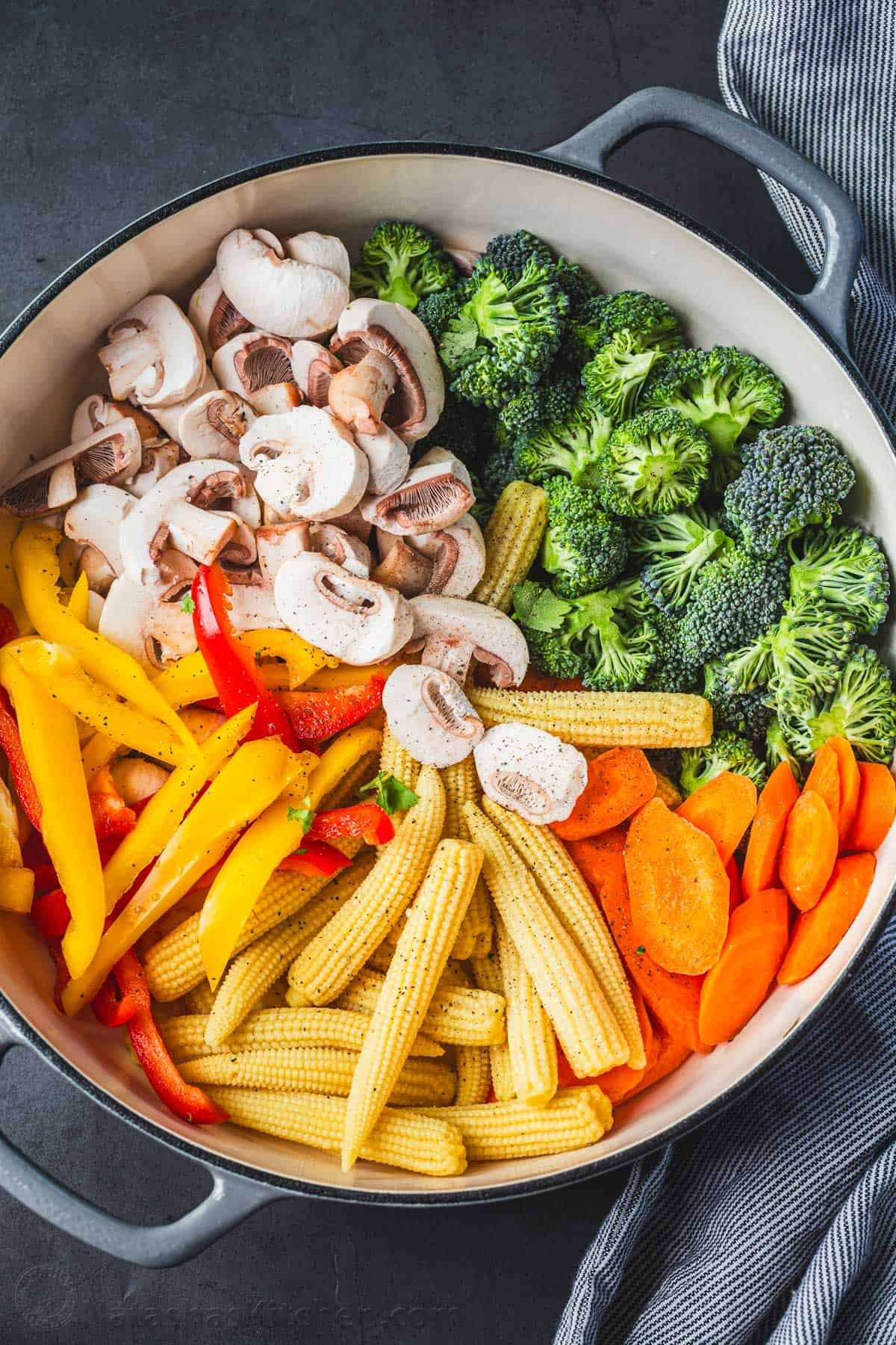 Ingredients for Chinese 30-minute veggie stirfry recipe with broccoli, carrots, mushrooms, baby corn, and sliced peppers.