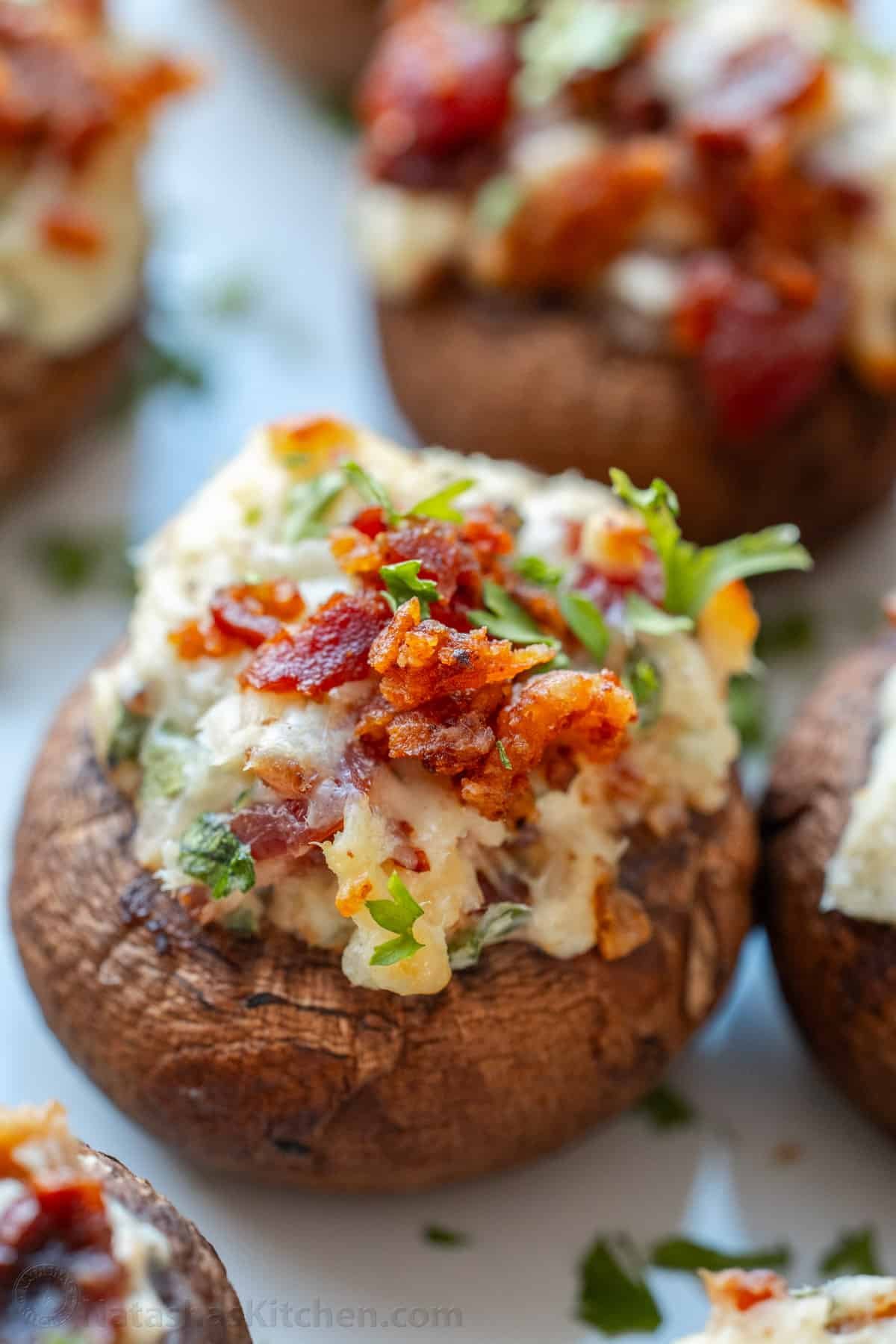 This is the best stuffed mushrooms recipe for your next party. The bite-sized appetizer is stuffed with cream cheese, bacon bites and garlic. Stuffed mushroom topped with bacon bits, parsley and cream cheese filling