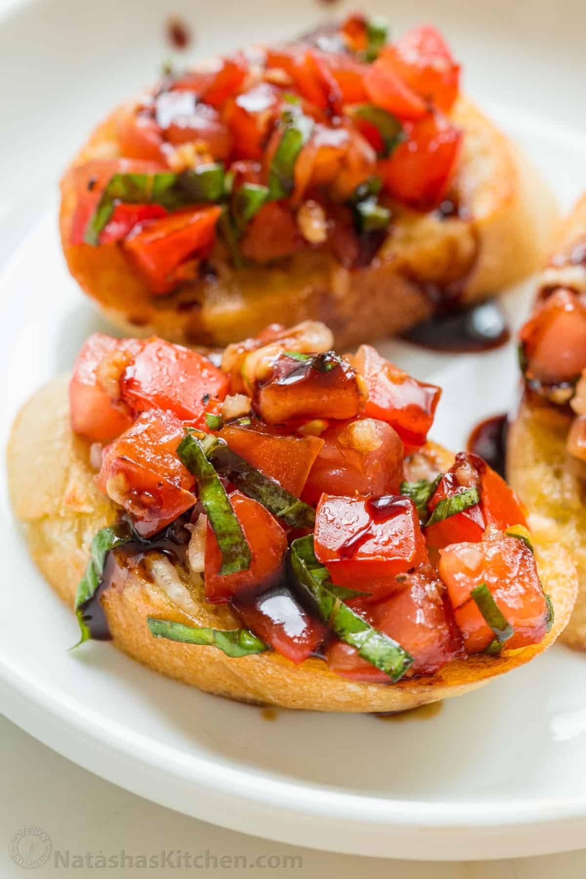 Up close Italian bruschetta topped with tomatoes and basil