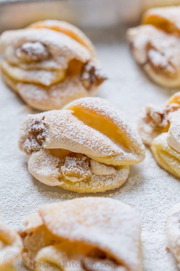 Meringue Shell Cookies have a crisp ribbon of meringue and soft crumbly center. These walnut meringue cookies are completely irresistible Christmas cookies! | natashaskitchen.com