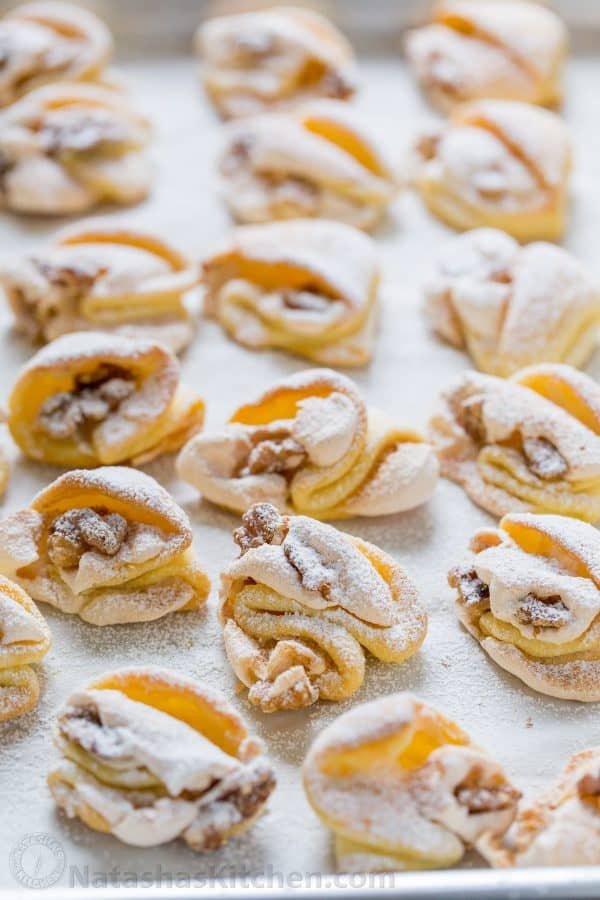 Meringue Shell Cookies have a crisp ribbon of meringue and soft crumbly center. These walnut meringue cookies are completely irresistible Christmas cookies! | natashaskitchen.com