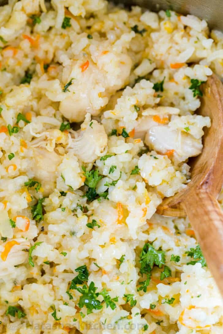 Cooked instant pot chicken and rice with mixing spoon