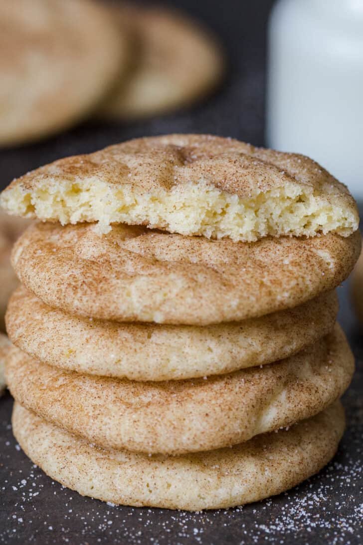 Snickerdoodle Cookies are a classic cookie loved by both kids and adults. They’re soft, sweet and slightly chewy. Cookies on top of each other with a broken cookie on top