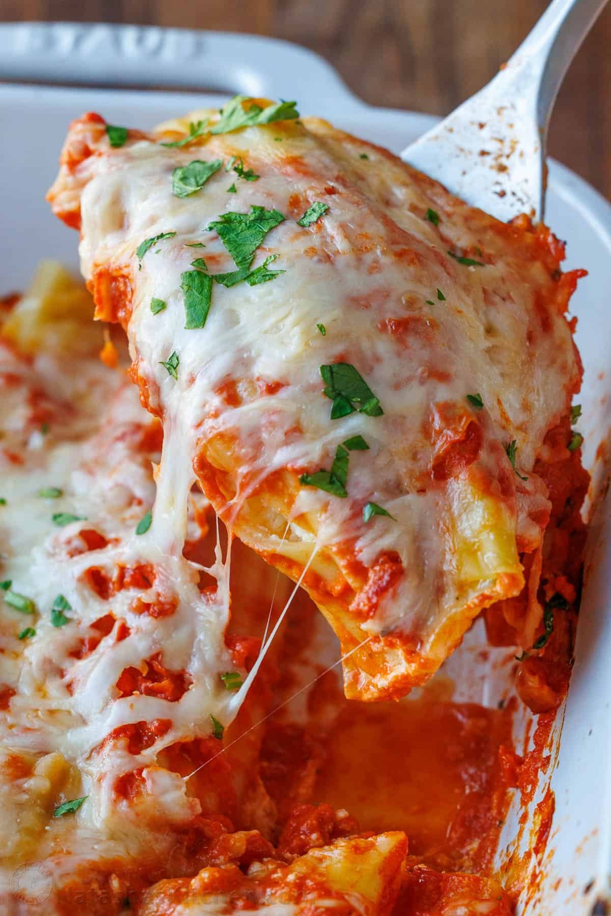 Our Stuffed Manicotti recipe has three kinds of cheese stuffed into perfectly cooked pasta, smothered in marinara sauce, and baked perfectly. Learn how to make the best stuffed manicotti! Manicotti recipe with stuffed pasta, cheese and marinara sauce