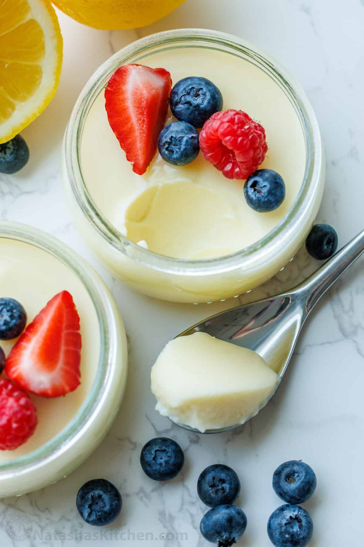 My 3-ingredient Lemon Posset recipe is a velvety smooth lemon custard. It's the perfect make-ahead dessert and cooks in 5 minutes on the stove Top shot of lemon posset recipe served in ramekins with a scoop on a spoon