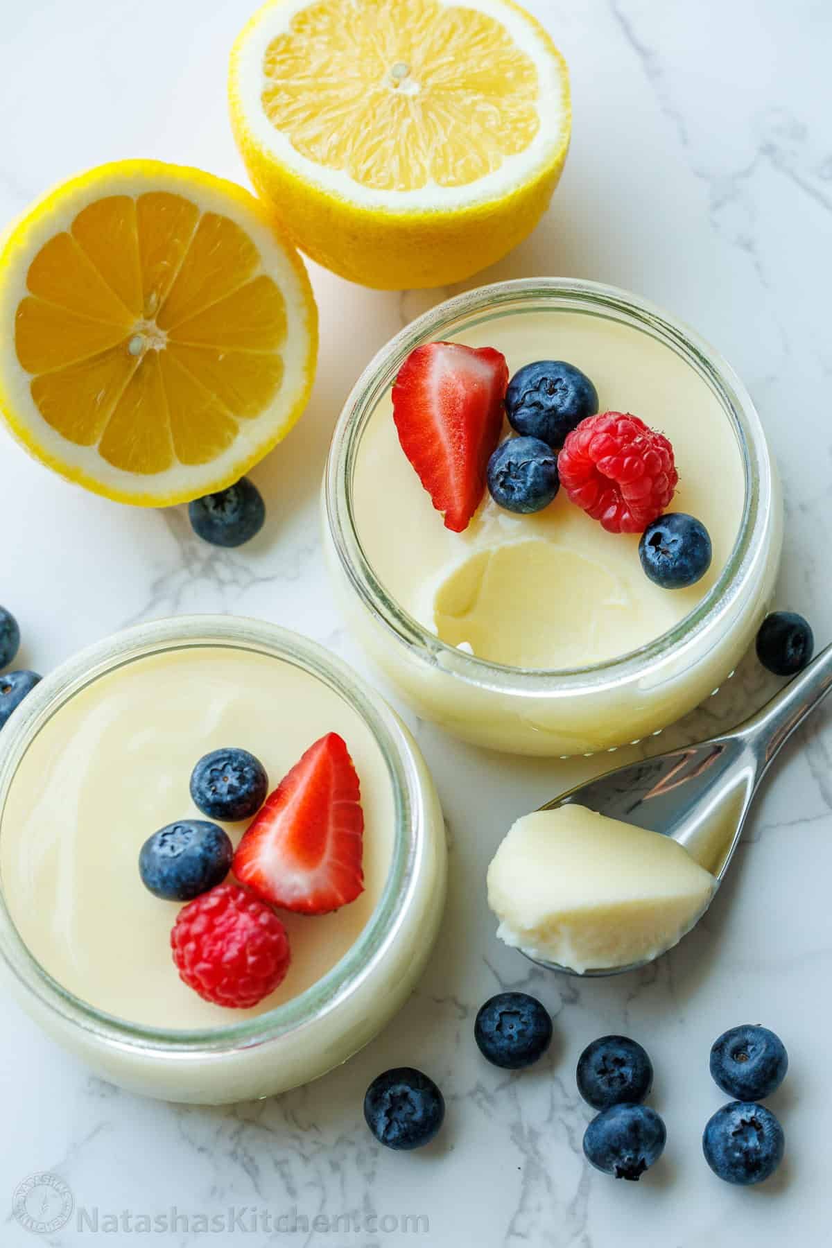 My 3-ingredient Lemon Posset recipe is a velvety smooth lemon custard. It's the perfect make-ahead dessert and cooks in 5 minutes on the stove British citrus custard dessert served in ramekins with berry garnish