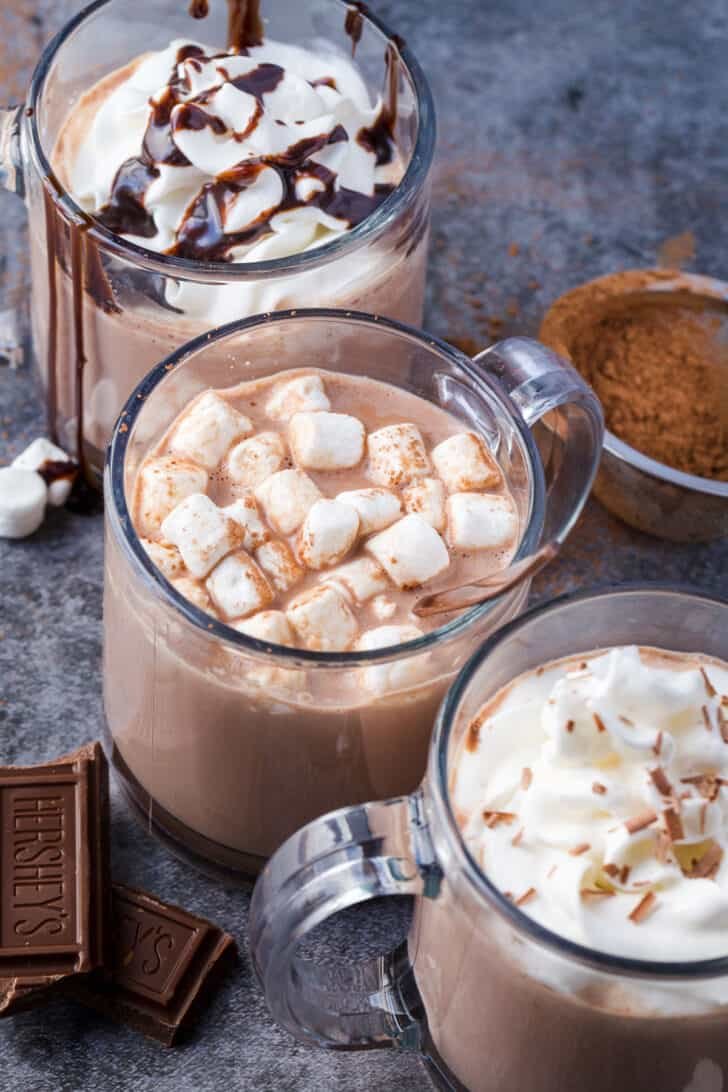 The ultimate homemade hot chocolate recipe that is ready in under 30 minutes and packed with creamy and rich flavors. hot chocolate topped with variety of toppings