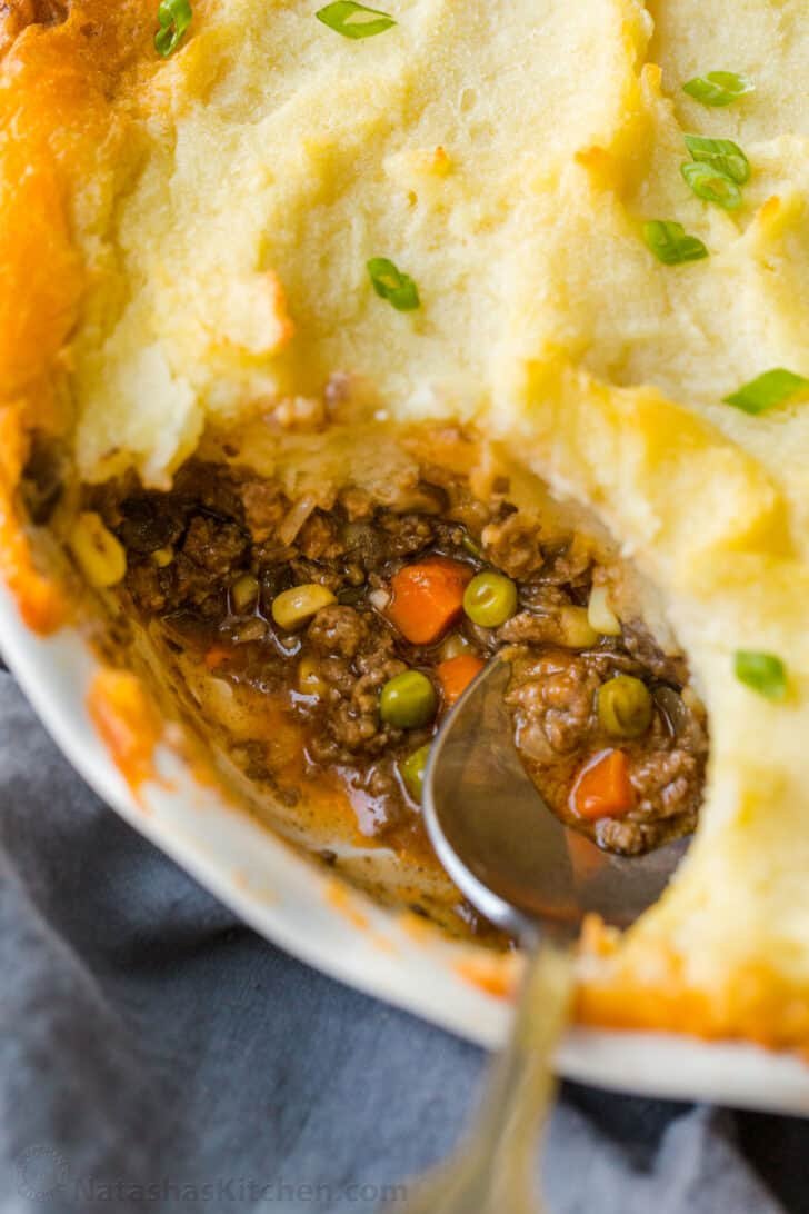 A homey and comforting Shepherd's Pie recipe with a meat and vegetable gravy sauce under a crown of creamy parmesan mashed potatoes. Cottage pie with meat sauce covered by mashed potatoes.