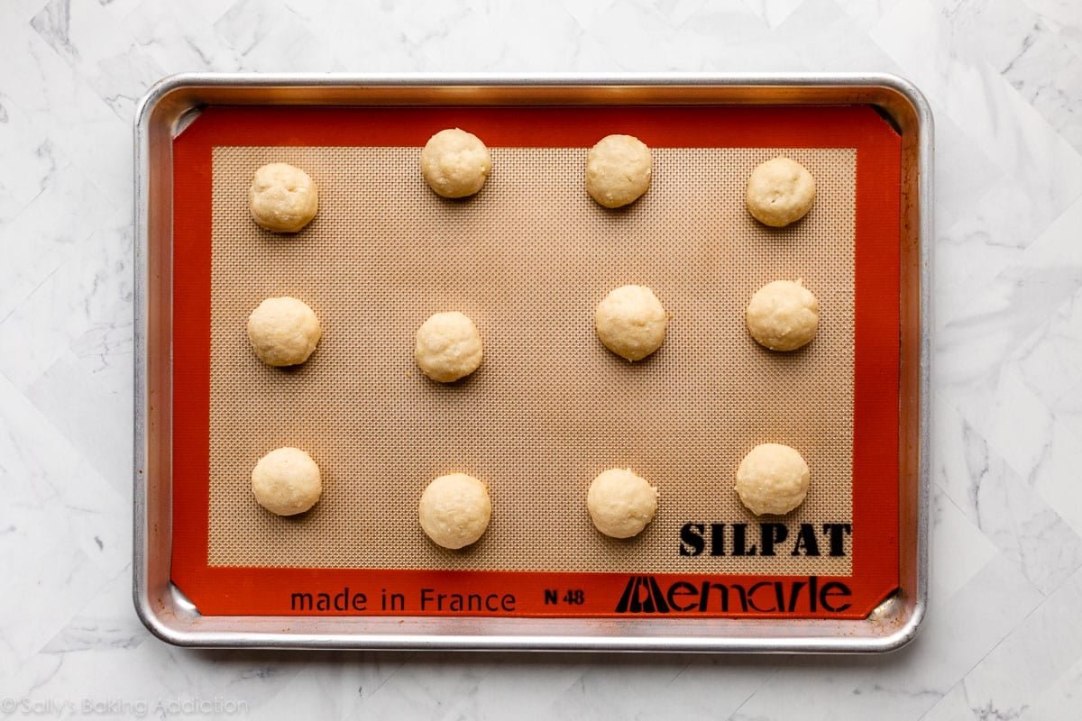 lemon coconut drop cookies on lined baking sheet