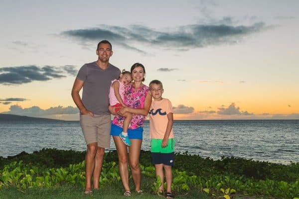 A family standing in front of a body of water