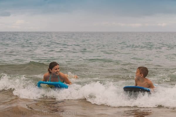 Natasha and her son using a Boogie board in the ocean 