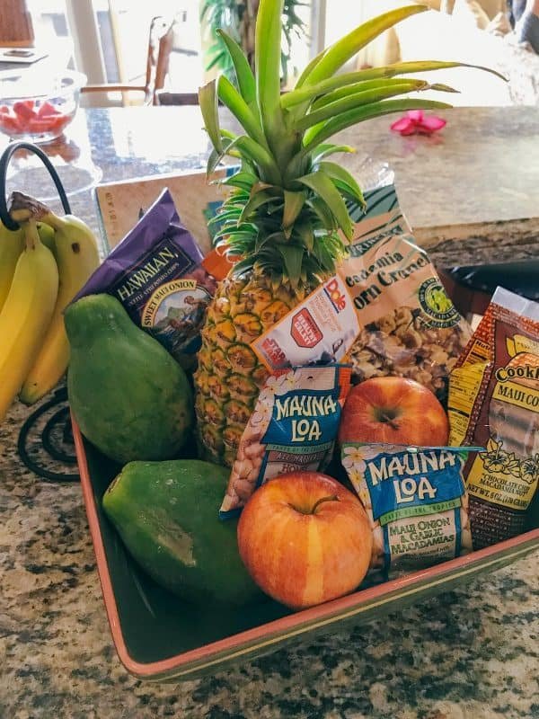 A tray on the table with fruits and other Hawaiian snacks 